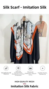 Detail view of floral faux silk square scarf with blue leaves and orange hemmed edges