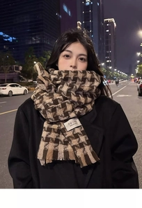 Detail of Korean style houndstooth scarf with classic fringe and branded textile label