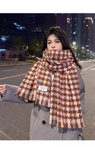 Detail of soft plaid scarf with classic tassels and Korean style woven brand label