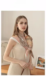 Elegant woman wearing a silk floral square scarf tied gracefully around her neck and shoulders