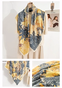 Detail of silk-feel scarf featuring vintage tropical palm prints and yellow-blue border