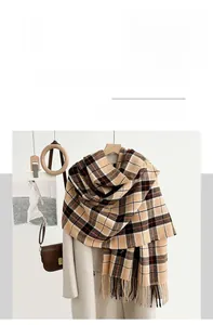 Detailed texture of imitation cashmere plaid scarf with tassels on a coat hanger
