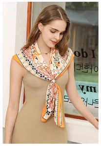 Close-up of Bohemian retro print silk scarf with silver star buckle and orange border