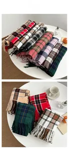 Close-up of classic plaid pattern and fringe tassel details on soft cashmere-like scarves