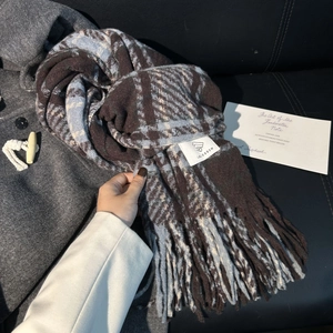 Winter plaid scarf in blue and brown with thick fringe details and brand woven label