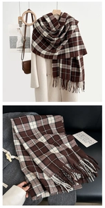 Detail of premium brown plaid scarf with thick fringe and soft faux cashmere texture