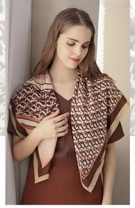 Detail of elegant herringbone pattern scarf with brown and white striped edges