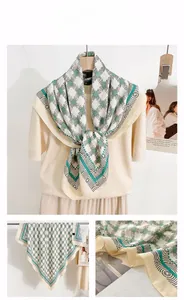 Close-up of vintage chain print silk scarf with green geometric patterns and soft sheen