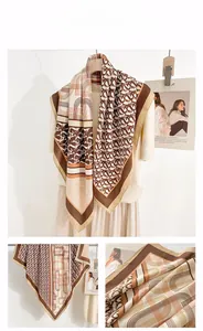 Detail of vintage geometric pattern and lettering print on a brown silk scarf