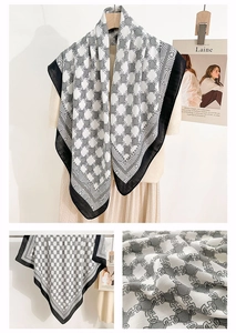 Detail of elegant herringbone square scarf with H-chain print and French retro pattern