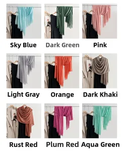 Detail view of cotton linen scarves in 9 solid colors with natural fringe edges
