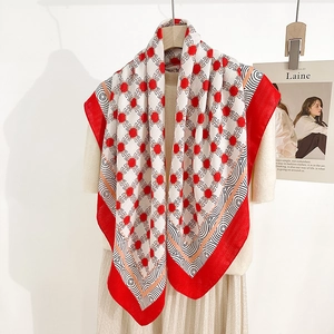 Elegant red and cream square silk scarf with chain pattern on a wooden hanger
