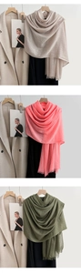 Detailed texture of linen scarf in beige, coral and green with soft frayed edges