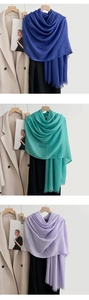 Detail of lightweight cotton linen scarves featuring frayed edges and wrinkled texture