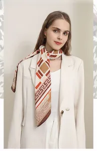 Detailed view of geometric herringbone silk scarf styled with a professional white blazer