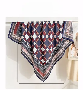 Detail of 90x90cm square silk scarf featuring geometric pattern in navy and red
