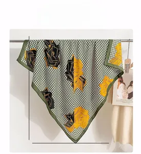 Detail of 90x90cm houndstooth scarf featuring large yellow rose floral print patterns