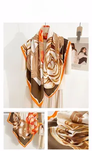 Detail of floral print silk scarf with orange borders and abstract vintage pattern