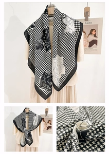 Detail of floral printed scarf with classic houndstooth pattern and soft fabric texture