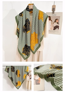Detail of green and white houndstooth scarf with yellow floral patterns and knit texture