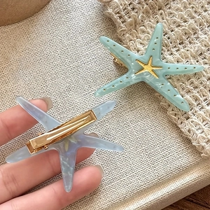Chic acetate starfish hair clips in blue and green with gold metal starfish accents