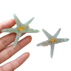 Starfish hair clips in blue and teal marble acetate with gold metal accents
