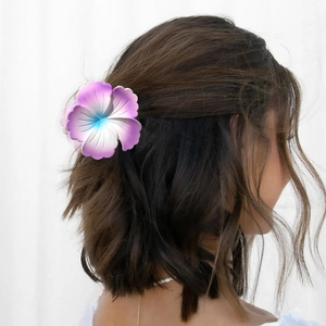 Detail view of a matte floral hair claw clip featuring a pink and blue gradient design