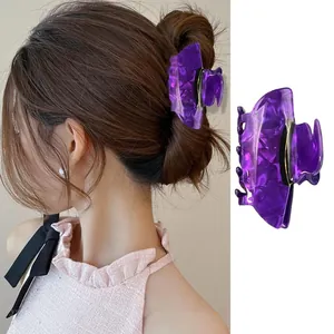 Detail view of purple marbled acrylic witch hat hair claw clip with a secure metal spring