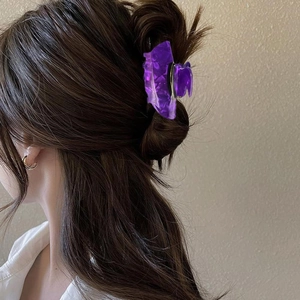 Detail of creative purple witch hat hair claw clip with geometric frosted texture