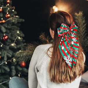 Rear view of Christmas bow hair clip with red-green snowflake stripes and long streamers