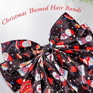 Close-up of black Christmas hair bow with Santa, snowman and candy cane festive prints