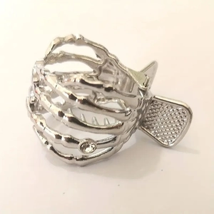Macro detail of silver metal skeleton hand hair claw with a single sparkling rhinestone