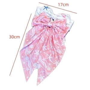 Detail view of pink starfish print hair bow showing 17cm width and 30cm long ribbons