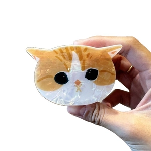 Pince à cheveux chat orange et blanc en acétate brillant avec texture nacrée élégante