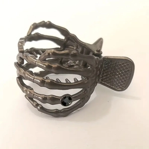 Detailed close-up of a punk style metal skull hand hair claw with a black rhinestone