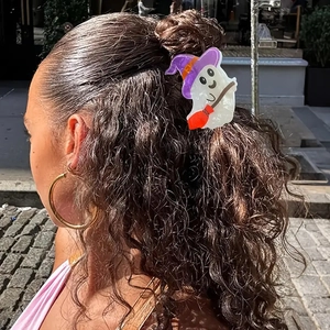 Detailed view of a ghost hair claw with a witch hat on styled wavy hair