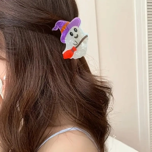 Ghost hair claw with purple witch hat and red broom on dark brown wavy hair
