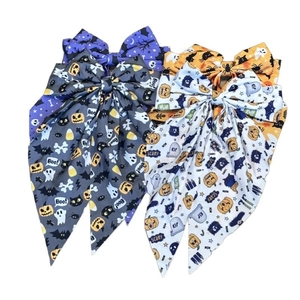 Set of four Halloween hair bows featuring pumpkin ghost prints and long ribbon streamers