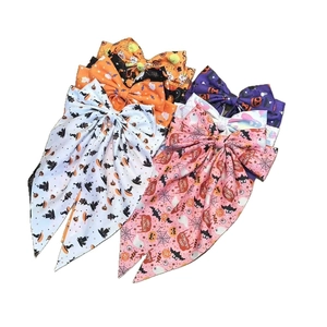 Close-up of Halloween hair bows with ghost, pumpkin and spider web printed patterns