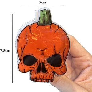 Orange skull pumpkin hair claw clip for Halloween party with crackle effect and green stem