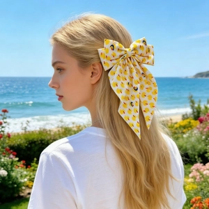 Détail d'un nœud papillon pour cheveux avec motifs canards jaunes porté à l'extérieur