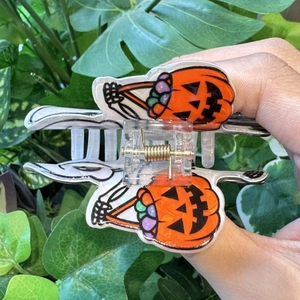 Macro view of Halloween pumpkin claw clip with strong metal spring and festive colors