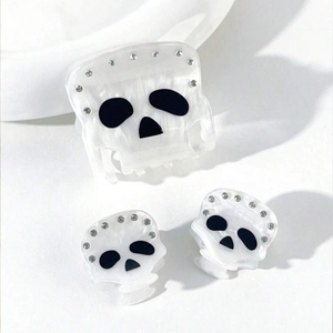 Detailed view of pearl white skull hair claw set with sparkling rhinestones for party