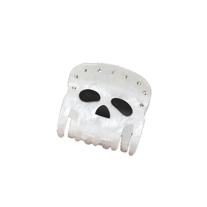 Detailed view of skull hair claw with pearl finish and sparkling rhinestone accents