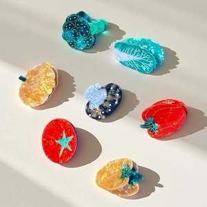 Close-up of high-quality acetate hair claws in creative vegetable shapes and textures