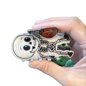 Halloween skull hair claw clip with orange pumpkin accent for party hair styling