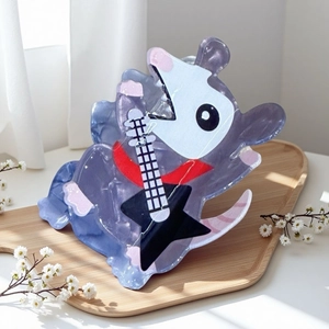 Close-up of cute cartoon singing mouse hair claw clip with purple marble texture