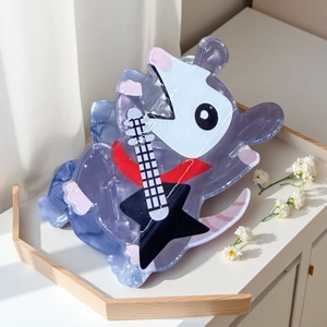 Close-up of a purple marble acetate hair claw clip featuring a cartoon mouse with a guitar