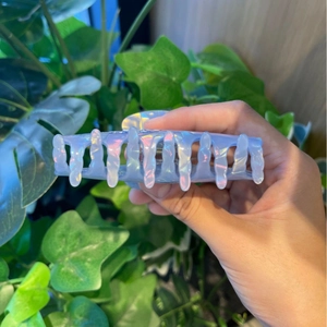 Iridescent light blue whale hair claw clip with fluid design for summer beach styling