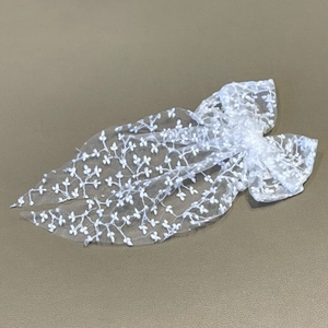 Elegant white lace bow hair clip with floral embroidery and long ribbons for weddings